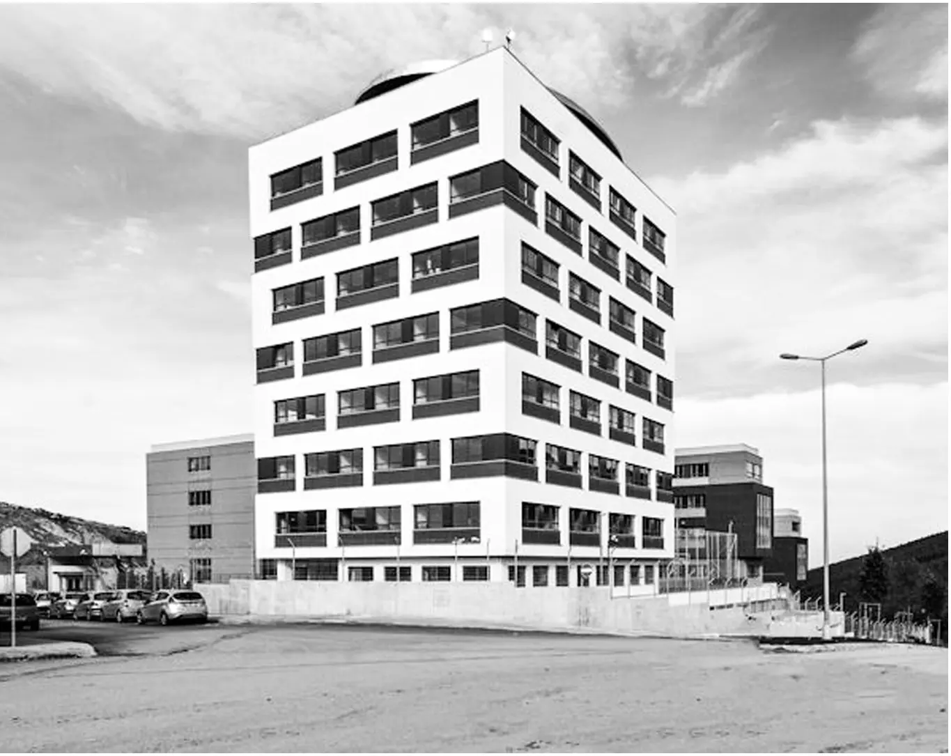 General view of the school building from the open forecourt; black and white.